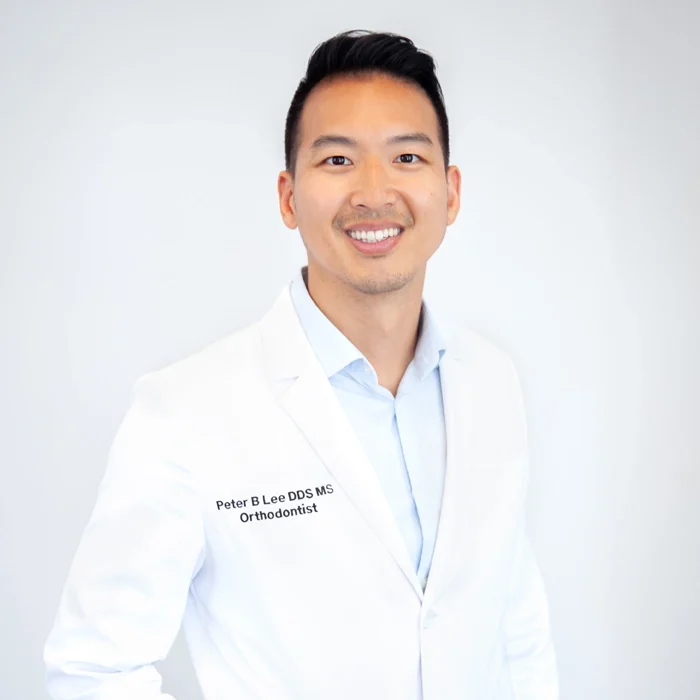 A professional photo of Dr. Peter Lee in a white coat